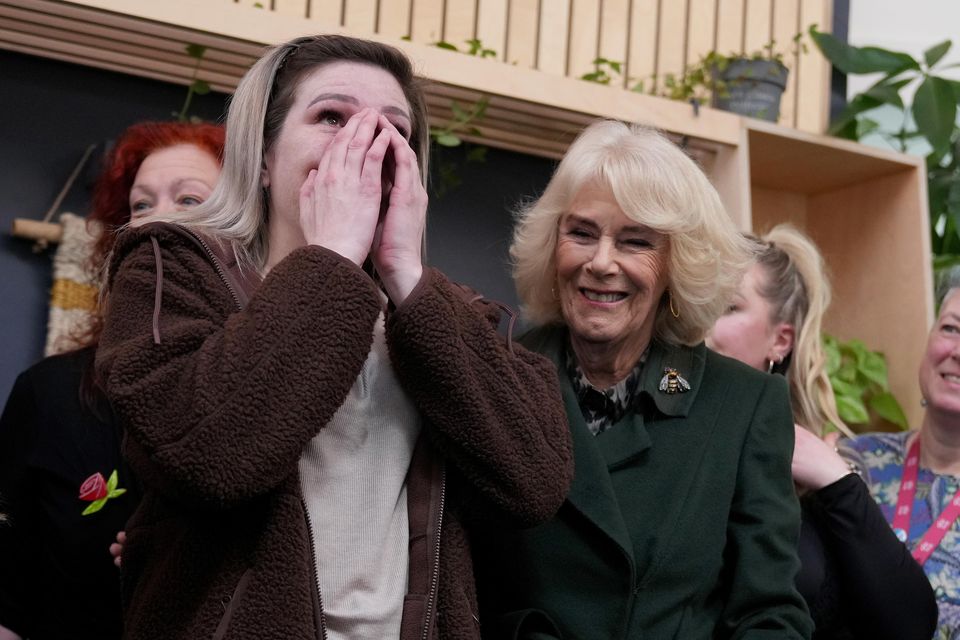 Queen Camilla comforts service user Sarah during a visit to CoLab Exeter (Alastair Grant/PA)