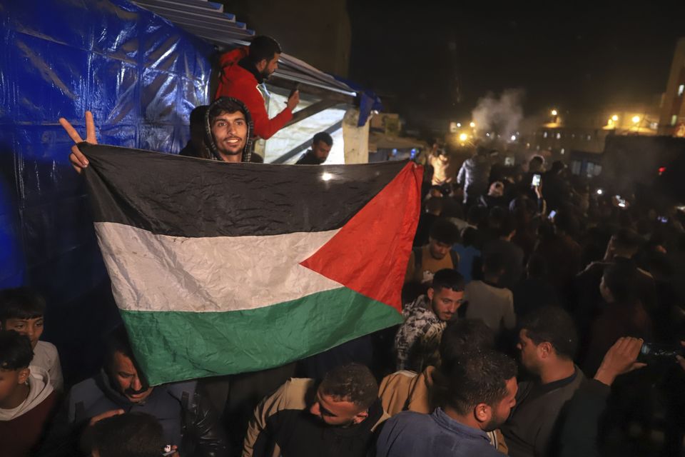 Palestinians celebrate the announcement of a ceasefire deal (Mariam Dagga/AP)