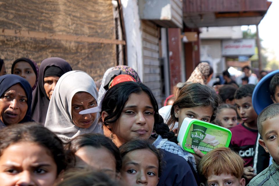 Palestinians queue up for food distribution in Deir al-Balah, Gaza Strip, in mid-October (Abdel Kareem Hana/AP)