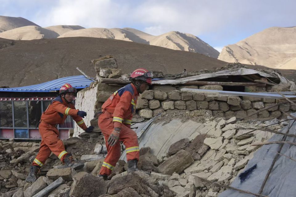 In this photo released by Xinhua News Agency, rescue workers conduct search and rescue for survivors in the aftermath of an earthquake in Changsuo Township of Dingri in Xigaze (Jigme Dorje/Xinhua/AP)