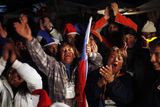 thumbnail: Relatives and friends of trapped miners celebrate while watching on a TV screen the rescue operation of Florencio Avalos at the camp outside the San Jose mine near Copiapo, Chile.