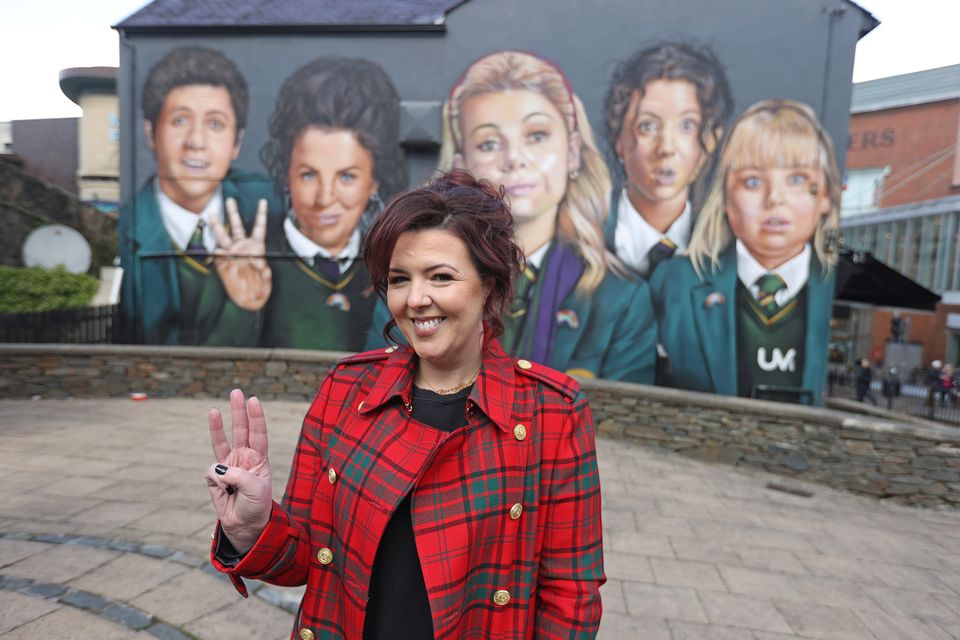 Derry Girls writer Lisa McGee in front of a Derry Girls mural in Londonderry (Liam McBurney/PA)