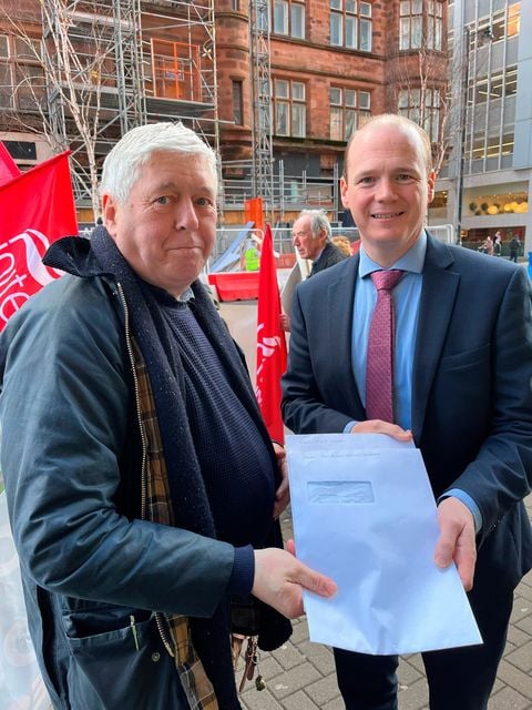 Brian Heading, Chair of the Unite retired members, handing over consultation responses to Minister Lyons