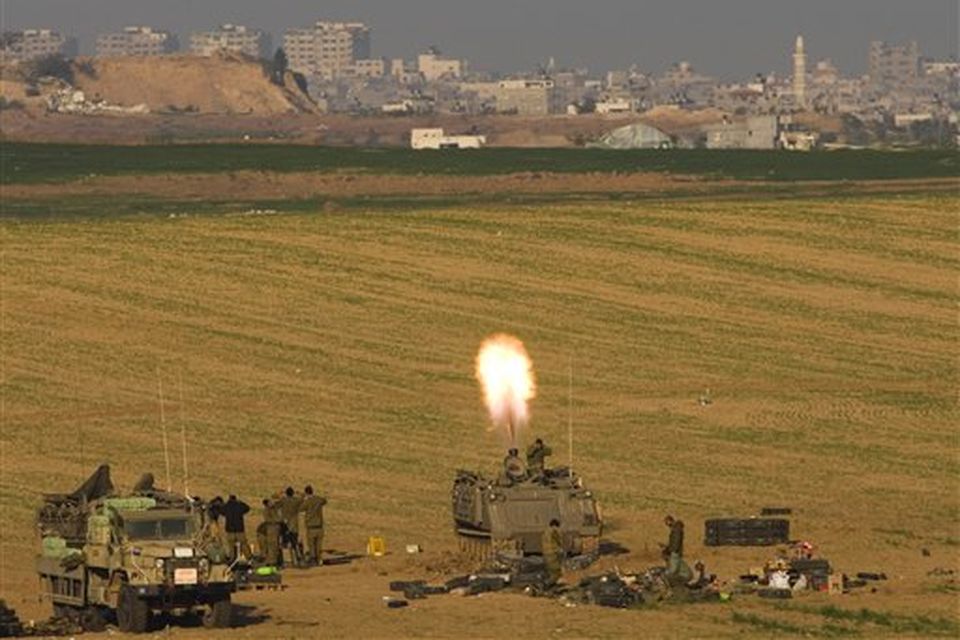 An Israeli army mortar squad fires a round towards a target in the Gaza Strip, from the Israel side of the border, in southern Israel, Monday Jan. 12, 2009. Israeli warplanes pounded the homes of Hamas leaders in the Gaza Strip and ground troops edged ever closer to the territory's densely-populated urban center Monday but reported casualties were low, an indication that Hamas was largely avoiding pitched battles with the advancing Israelis(AP Photo/Bernat Armangue)