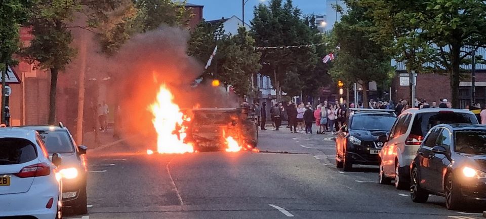 A vehicle is set alight in Belfast following an anti-Islamic protest outside Belfast City Hall (David Young/PA)