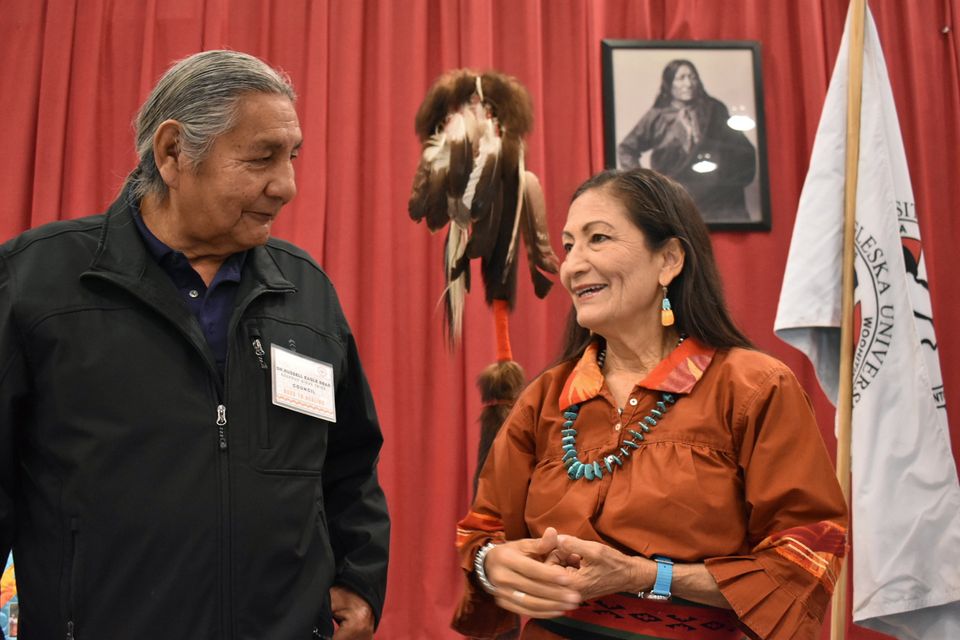 Russell Eagle Bear, with the Rosebud Sioux Reservation Tribal Council, speaks to Deb Haaland during a meeting about Native American boarding schools at Sinte Gleska University (Matthew Brown/AP)