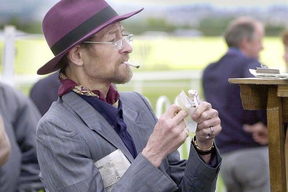 Former World Champion snooker star Alex Higgins enjoys a day out at the races despite fighting off the effects of throat cancer.