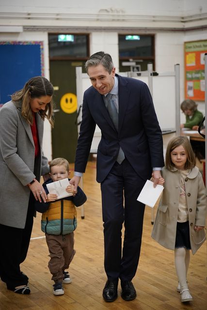 Mr Harris’s children, Cillian and Saoirse, accompanied their parents at the polling station (Niall Carson/PA)