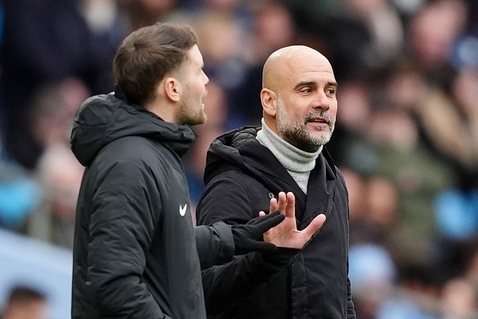 Manchester City manager Pep Guardiola, right, holds out a hand to silence Brighton boss Fabian Hurzeler on the touchline (Martin Rickett/PA)