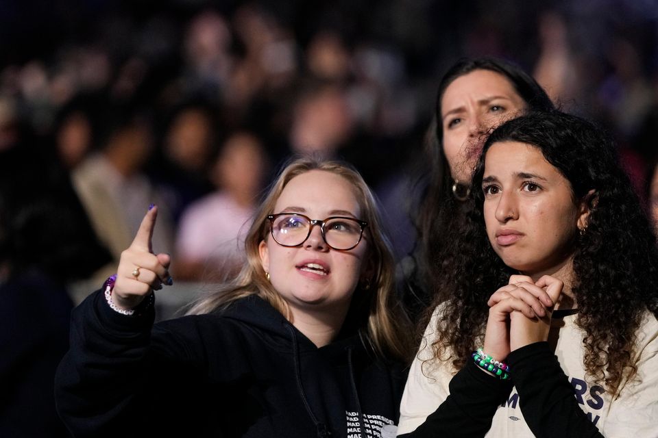 Supporters of Kamala Harris look at election results on the campus of Howard University in Washington (Mark Schiefelbein/AP)