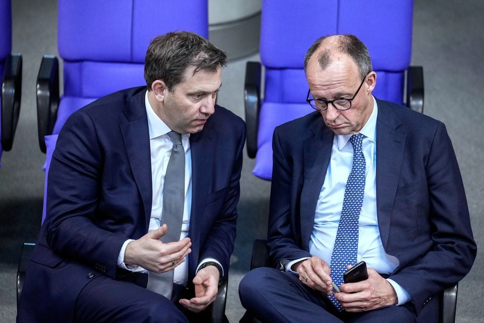 Friedrich Merz and Social Democratic Party leader Lars Klingbeil talk during a meeting of the German parliament, Bundestag (Ebrahim Noroozi/AP)