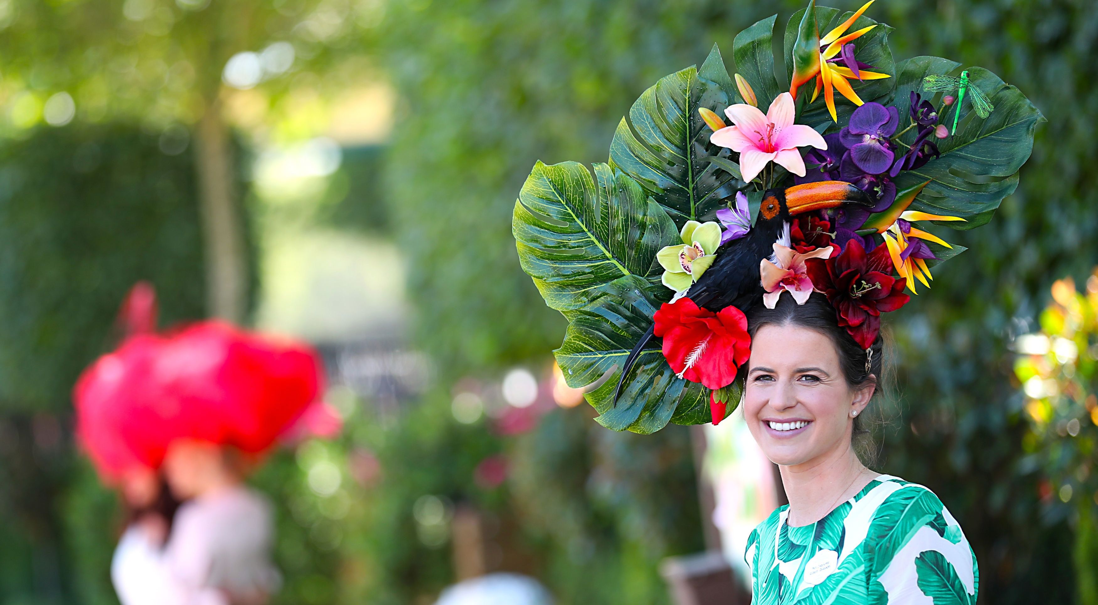 Pretty: A racegoer in a cheerful pink and green hat and form