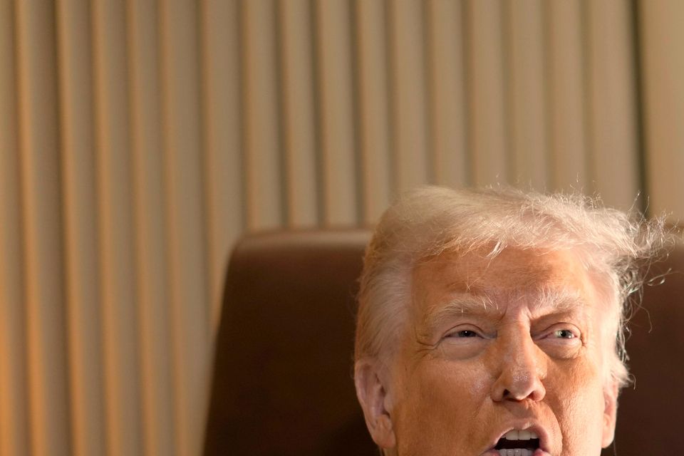 President Donald Trump speaks to reporters aboard Air Force One (Ben Curtis/AP)