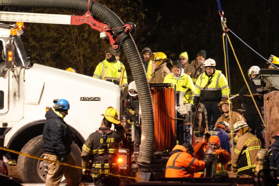 Rescue workers search in a sinkhole for Elizabeth Pollard (Gene J Puskar/AP)