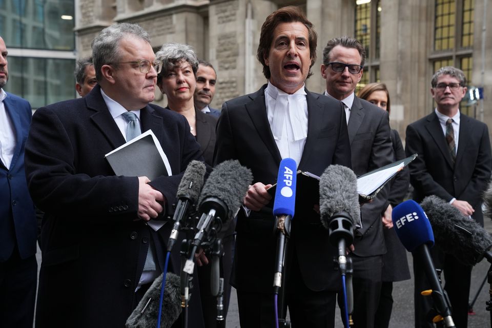 Lord Watson and Harry’s barrister, David Sherborne, speaks to the media after the legal action against the publisher of The Sun was settled on Wednesday (Lucy North/PA)