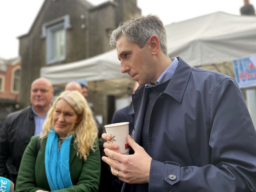 Taoiseach and Fine Gael leader Simon Harris takes part in a canvass around a Christmas market at Rarhfarnham Parish Hall, Dublin (PA)