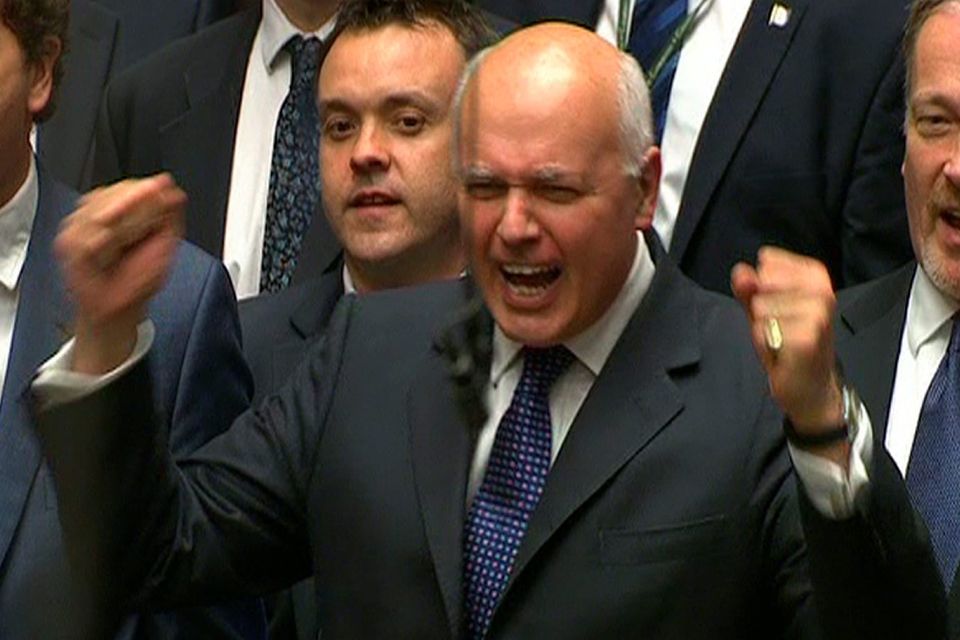 Works and Pensions Secretary Iain Duncan Smith punches the air as he listens to Chancellor of the Exchequer reveal details of the 2015 Budget