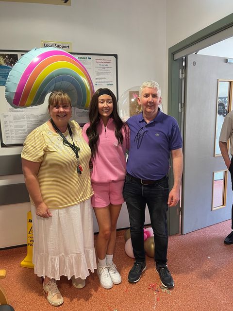 Abbie with her mum and dad at end of chemo in hospital.