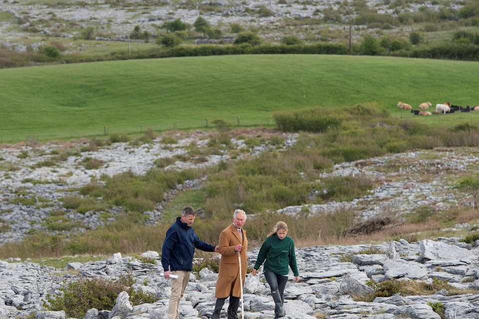 THE BURREN, IRELAND - MAY 19:  Prince Charles, Prince of Wales with Brendan Dunford manager of Burren Life and Bridgid Barry Burrenbeo during his visit to The Burren, an ancient and dramatic stony outcrop famed for its rare plant life, biodiversity and archaeology, on the first day of his Royal visit to the Republic of Ireland on May 19, 2015 in County Clare, Ireland. The Prince of Wales and Duchess of Cornwall arrived in Ireland today for their four day visit to the Republic and Northern Ireland, the visit has been described by the British Embassy as another important step in promoting peace and reconciliation. (Photo by Eddie Mulholland - WPA Pool/Getty Images)