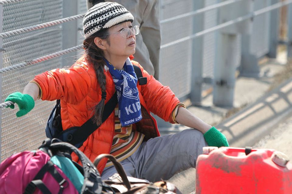 SENDAI, JAPAN - MARCH 14:  A local resident rests as she evacuates an area after a 9.0 magnitude strong earthquake struck on March 11 off the coast of north-eastern Japan, on March 14, 2011 in Sendai, Japan. The quake struck offshore at 2:46pm local time, triggering a tsunami wave of up to 10 metres which engulfed large parts of north-eastern Japan. The death toll is currently unknown, with fears that the current hundreds dead may well run into thousands.  (Photo by Kiyoshi Ota/Getty Images)