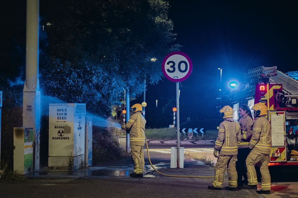 Firefighters deal with an arson at a 5G mast on the Monagh Bypass in west Belfast on July 31st 2024 (Photo by Kevin Scott)
