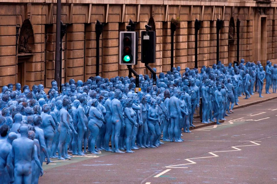 Naked volunteers, painted in blue to reflect the colours found in Marine paintings in Hull's Ferens Art Gallery, prepare to participate in US artist, Spencer Tunick's "Sea of Hull" installation in Kingston upon Hull on July 9, 2016. AFP/Getty Images