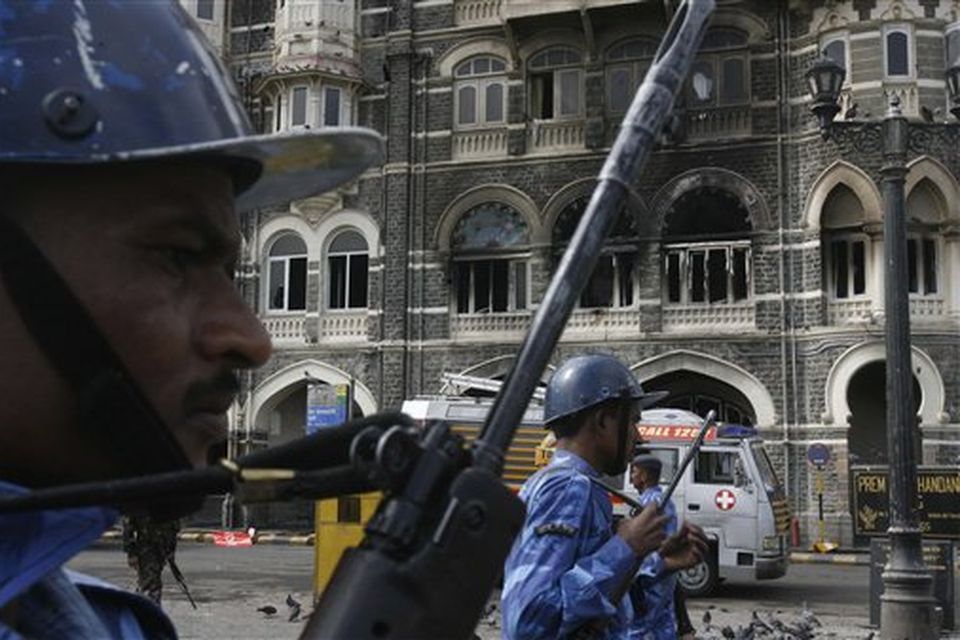 Members of the Rapid Action Force walk in front of Taj Mahal hotel in Mumbai, India, Saturday, Nov. 29, 2008. Indian commandos killed the last remaining gunmen holed up at the luxury Mumbai hotel Saturday, ending a 60-hour rampage through India's financial capital by suspected Islamic militants that killed people and rocked the nation. (AP Photo/Gautam Singh)