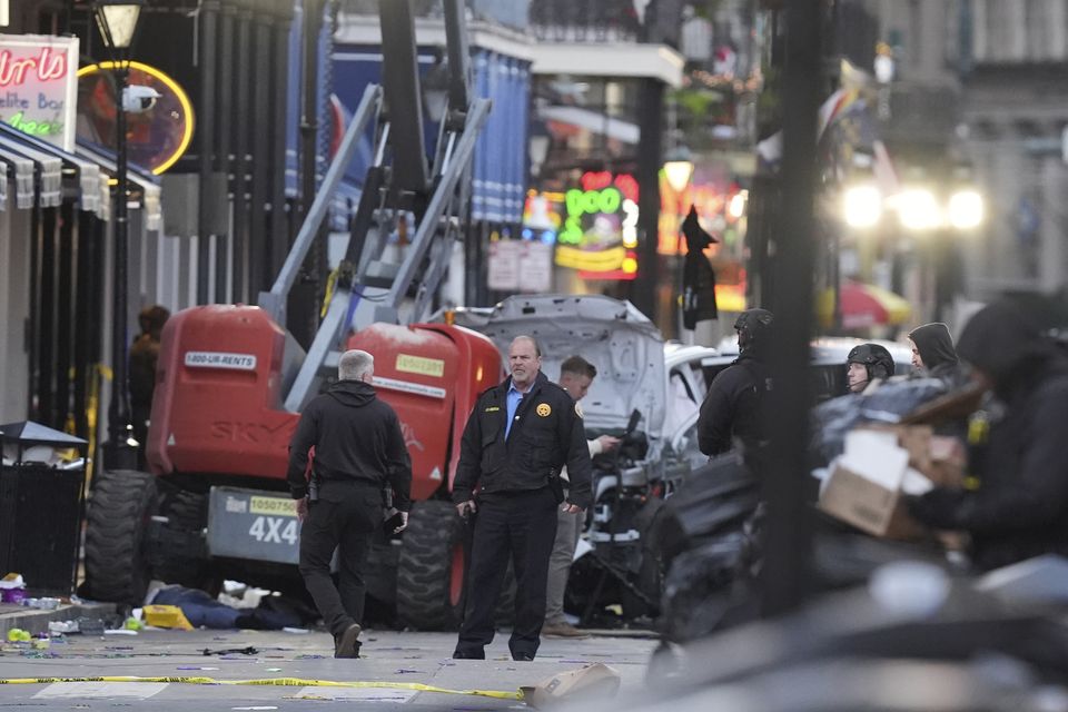 Security personnel investigate the scene on Bourbon Street (Gerald Herbert/AP)