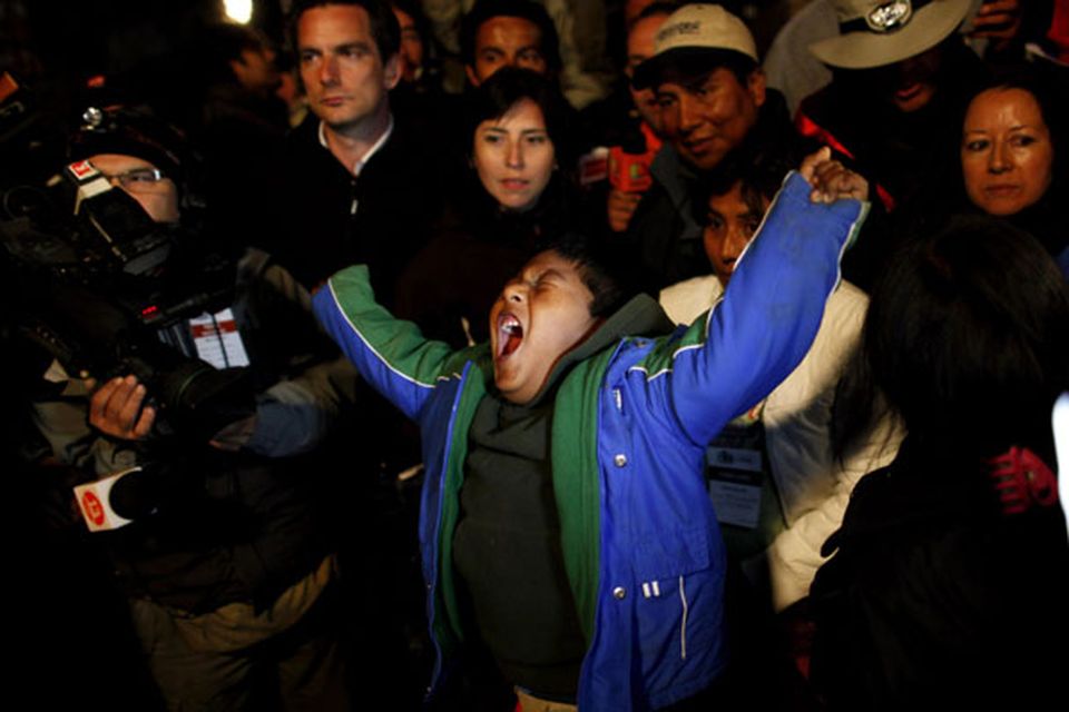 Marcelo Vilquinina, nephew of trapped miner Carlos Mamani Solis, yawns as he watches rescue operations on TV from the camp outside the San Jose mine near Copiapo, Chile, Wednesday Oct. 13, 2010. Thirty-three miners became trapped when the gold and copper mine collapsed on Aug. 5. Mamani was the fourth miner to be rescued. (AP Photo/Natacha Pisarenko)