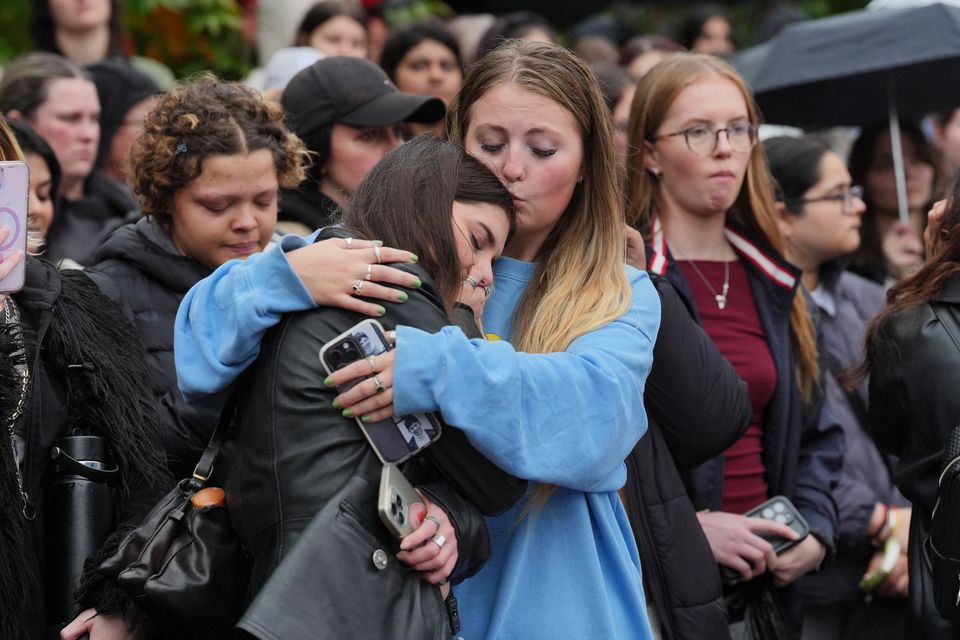 People attend a London vigil for Liam Payne, who rose to fame with the boy band on The X Factor (Jonathan Brady/PA)