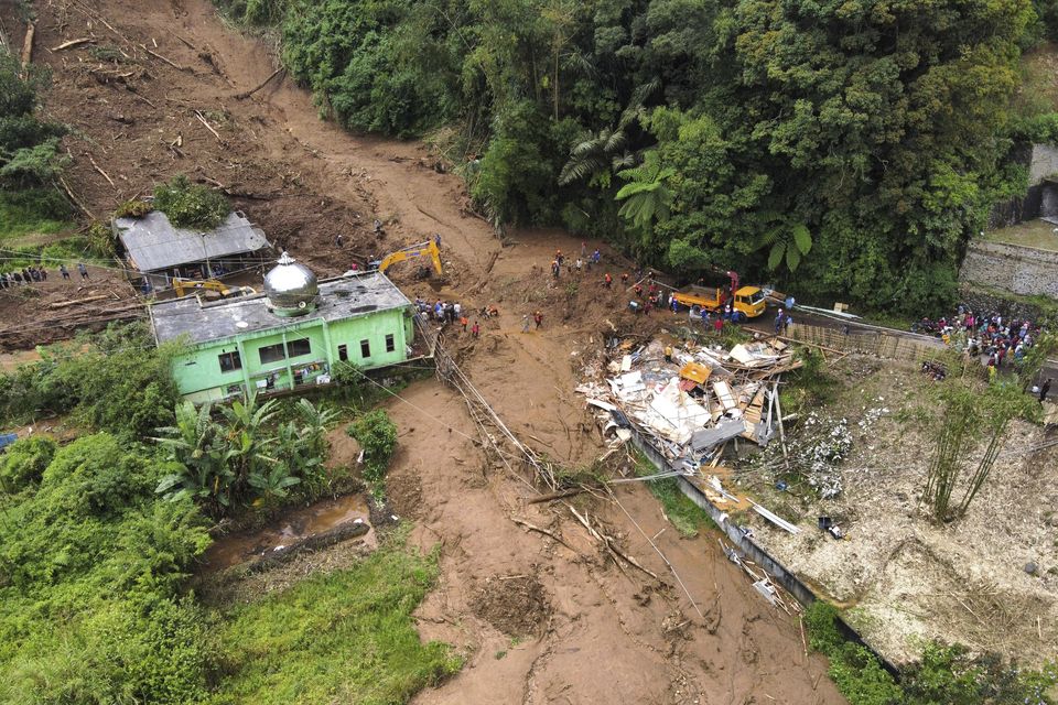 Rescuers search for victims after a landslide that killed a number of people and left some others missing in Karo, North Sumatra, Indonesia (AP/Binsar Bakkara)