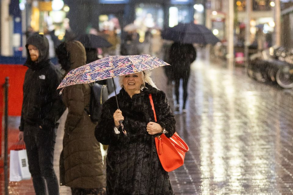 Battling the rain in Belfast during Storm Darragh last month. Image: Luke Jervis /Belfast Telegraph