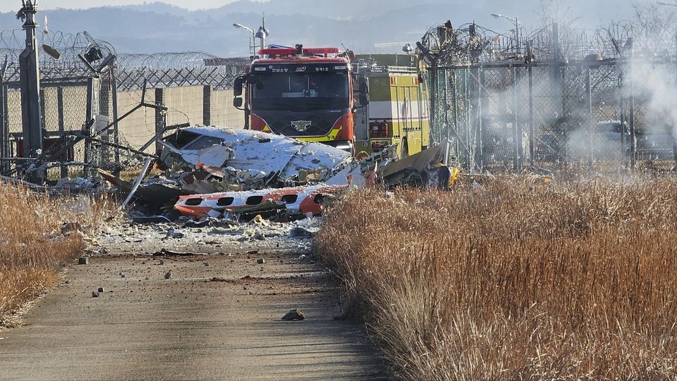 Fire engines work to extinguish a fire at the Muan International Airport (Maeng Dae-hwan/Newsis/AP)