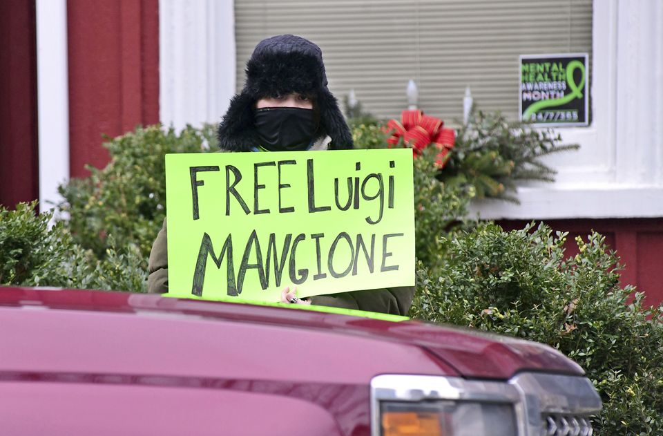 An unidentified woman protests for the release of Luigi Mangione outside the courthouse (Thomas Slusser/The Tribune-Democrat via AP)