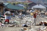 thumbnail: Residents of the seaside town of Toyoma, northern Japan, carry belongings from their homes Monday, March 14, 2011, three days after a giant quake and tsunami struck the country's northeastern coast. (AP Photo/Mark Baker)