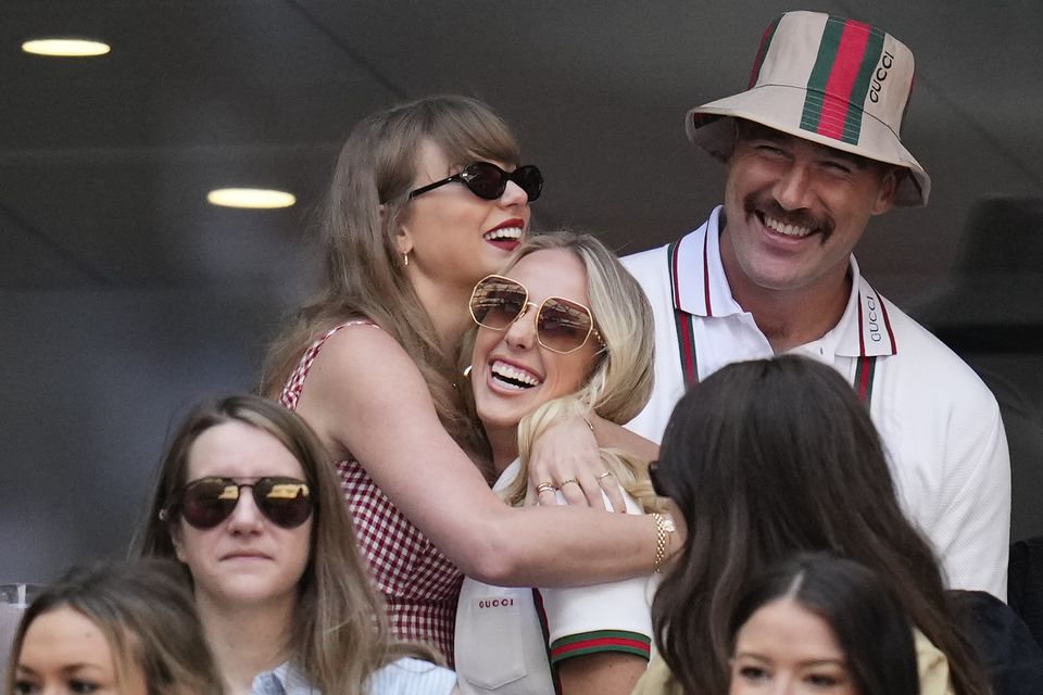 Taylor Swift hugs Brittany Mahomes as Travis Kelce looks on (Kirsty Wigglesworth/AP)