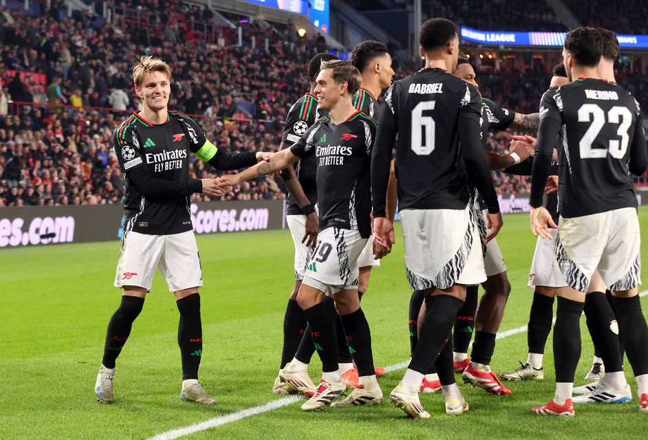 Martin Odegaard, left, celebrates with team-mates after scoring his first goal and Arsenal’s fourth in Eindhoven (Peter Lous/PA)