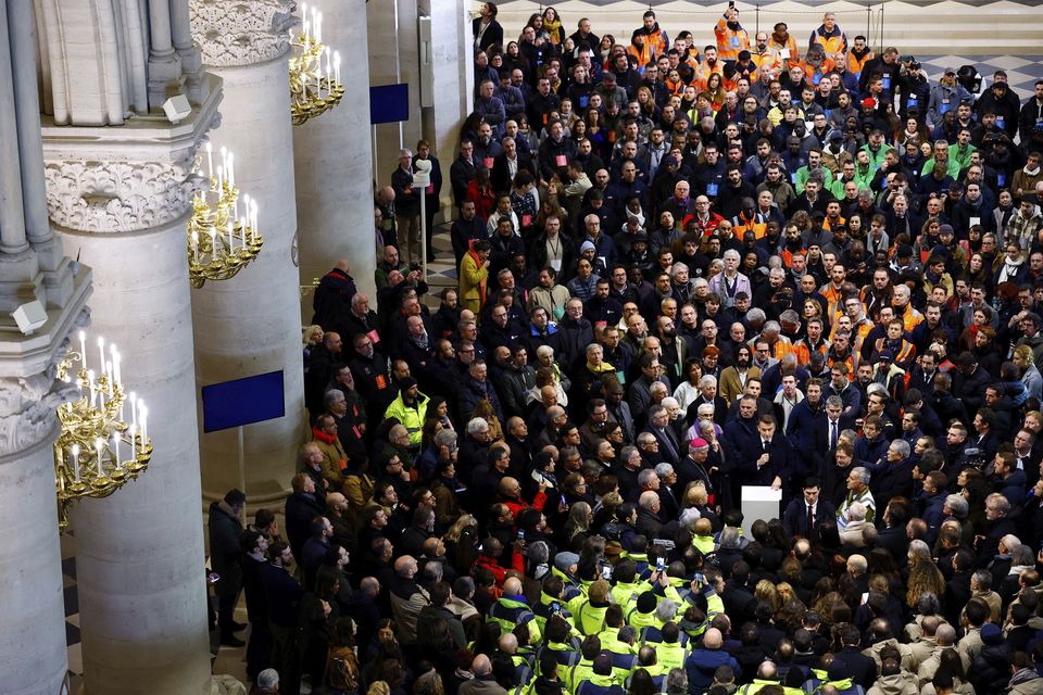 Mr Macron gave a speech to construction workers inside the building after visiting the restored interiors they had repaired (Sarah Meyssonnier, pool via AP)