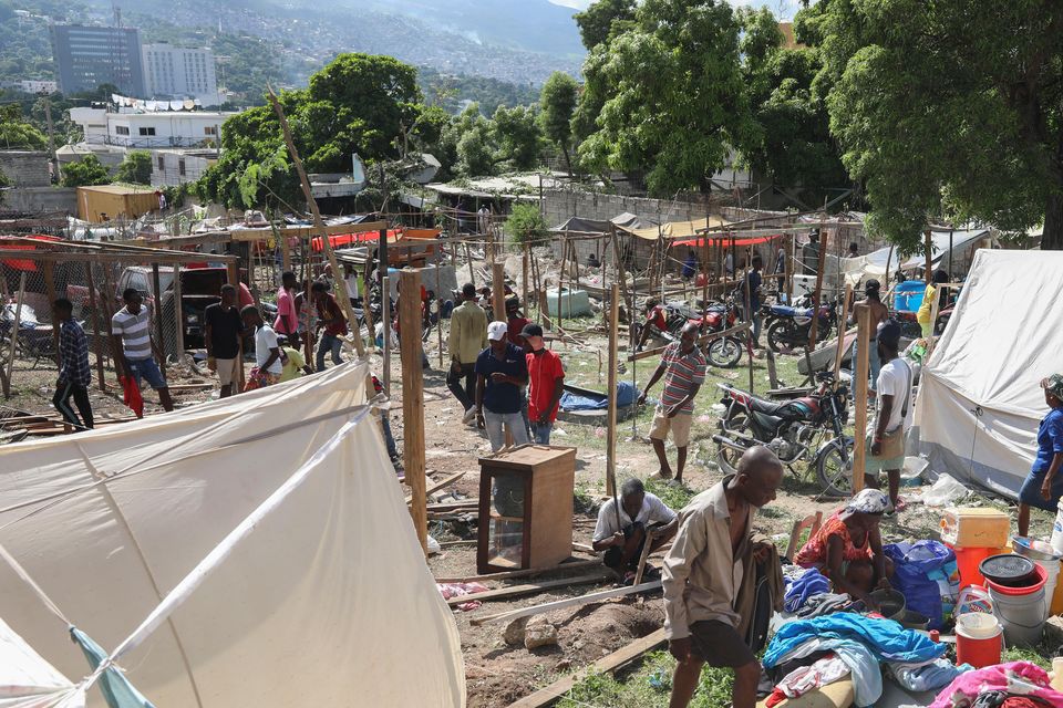 Residents of the Nazon neighbourhood displaced by gang violence construct a tent encampment in Port-au-Prince, Haiti (Odelyn Joseph/AP)