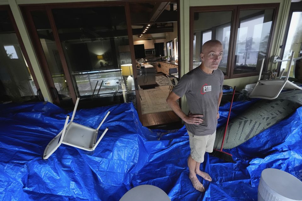 Christian Burke stands on the third floor of his home, where he, his mother, and his aunt plan to ride out Hurricane Milton (Rebecca Blackwell/AP)