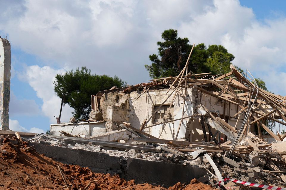 A man takes photos of a destroyed building that was hit in Iran’s missile attack in Hod Hasharon, Israel, early in October (Ariel Schalit/AP)