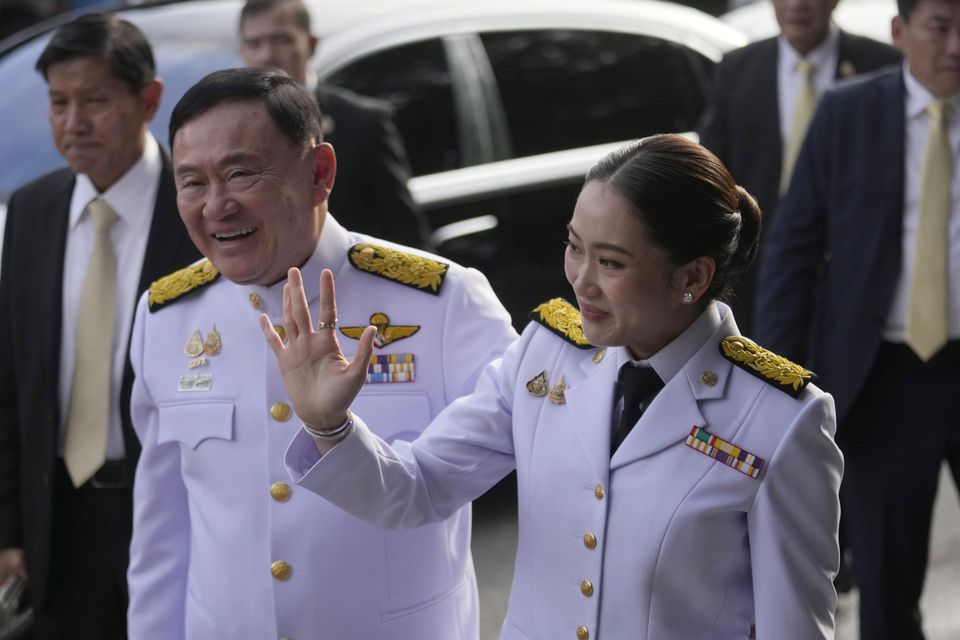 Thailand’s former Prime Minister Thaksin Shinawatra, left, and his daughter and newly elected Prime Minister Paetongtarn Shinawatra arrive at the ceremony (Sakchai Lalit/AP)