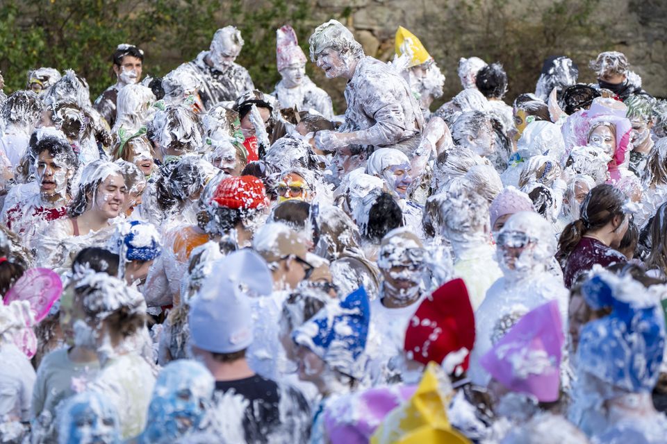 Students take part in the traditional Raisin Monday foam fight on St Salvator’s Lower College Lawn at the University of St Andrews (Jane Barlow/PA)