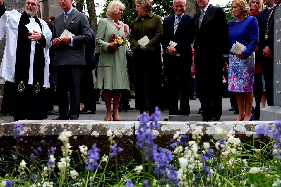 SLIGO, IRELAND - MAY 20:  (L-R) The Very Rev. Arfon Williams, Prince Charles, Prince of Wales and Camilla, Duchess of Cornwall, Former President of Ireland Mary McAleese, Martin McAleese, and Minister of Foreign Affairs Charlie Flanagan attend a tree planting ceremony after a service of peace and reconciliation at St. Columba's Church in Drumcliffe on the second day of a four day visit to Ireland on May 20, 2015 in Sligo, Ireland. The Prince of Wales and Duchess of Cornwall arrived in Ireland yesterday for their four day visit to the Republic and Northern Ireland, the visit has been described by the British Embassy as another important step in promoting peace and reconciliation.  (Photo by Brian Lawless - WPA Pool/Getty Images)