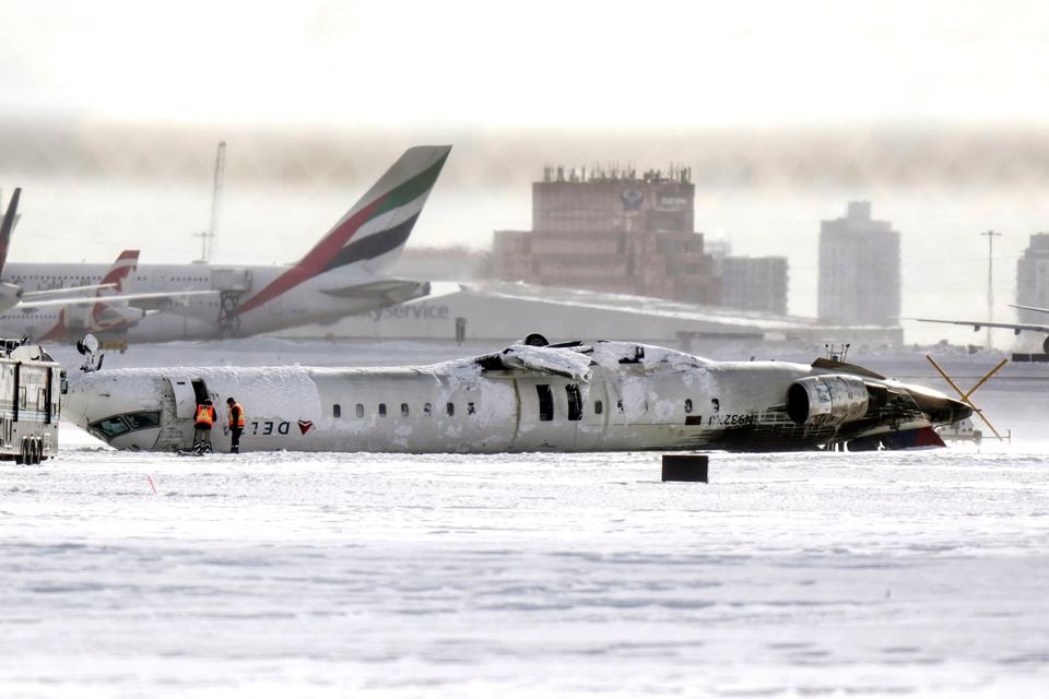 Investigations are under way to determine how the plane lost its wing and ended upside down (Chris Young/The Canadian Press via AP)