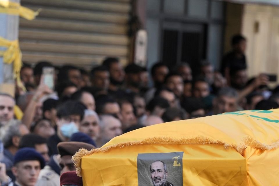 Hezbollah members carry the coffin of drone commander Mohammed Hussein Surour (Bilal Hussein/AP)