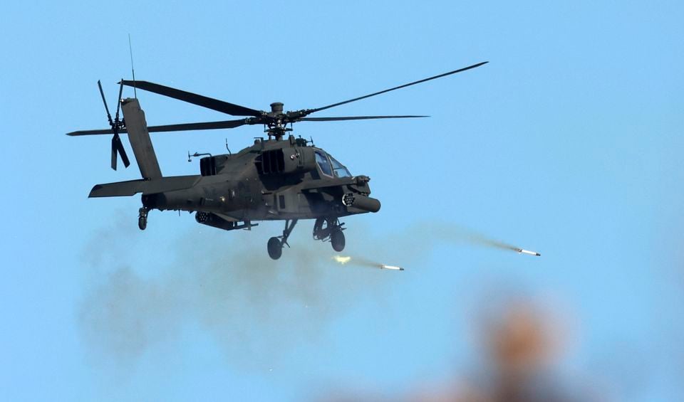 A South Korea army’s Apache Guardian helicopter fires rockets during the joint military drill between South Korea and the United States at Seungjin Fire Training Field in Pocheon, South Korea (Yonhap via AP)