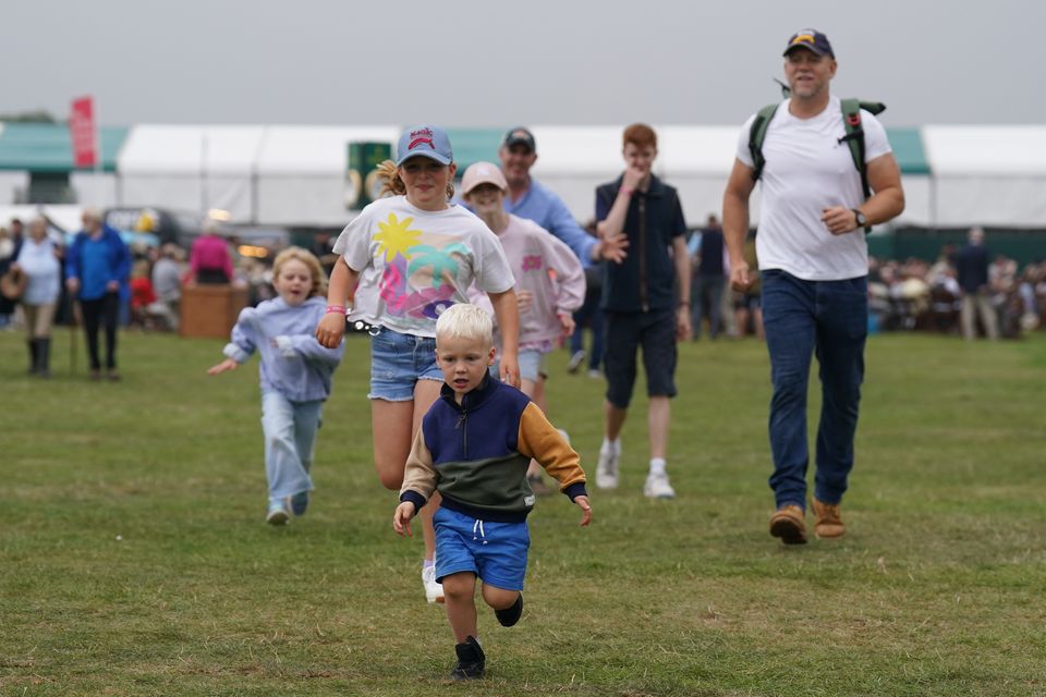 The three children ran around the event with their father in tow (Joe Giddens/PA)