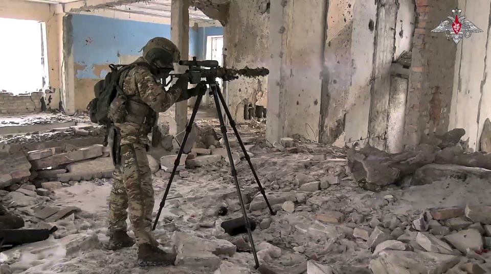 A Russian Army sniper fires toward Ukrainian position at an undisclosed location in Ukraine (Russian Defence Ministry Press Service via AP)