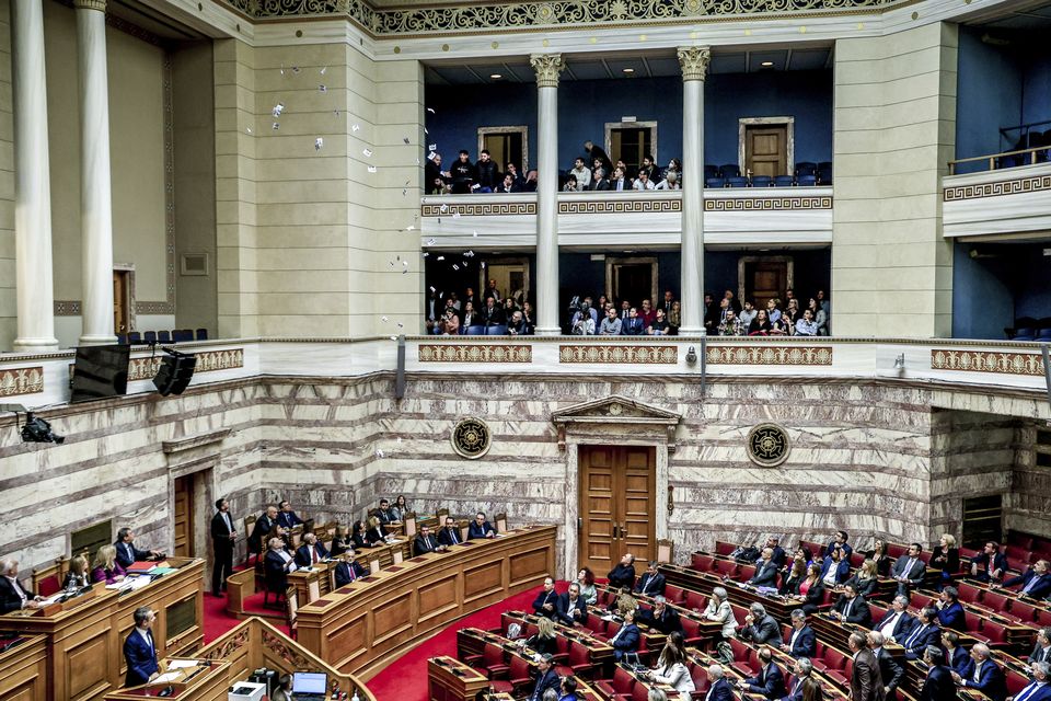 Protesters threw leaflets as Greece’s Prime Minister Kyriakos Mitsotakis (AP)